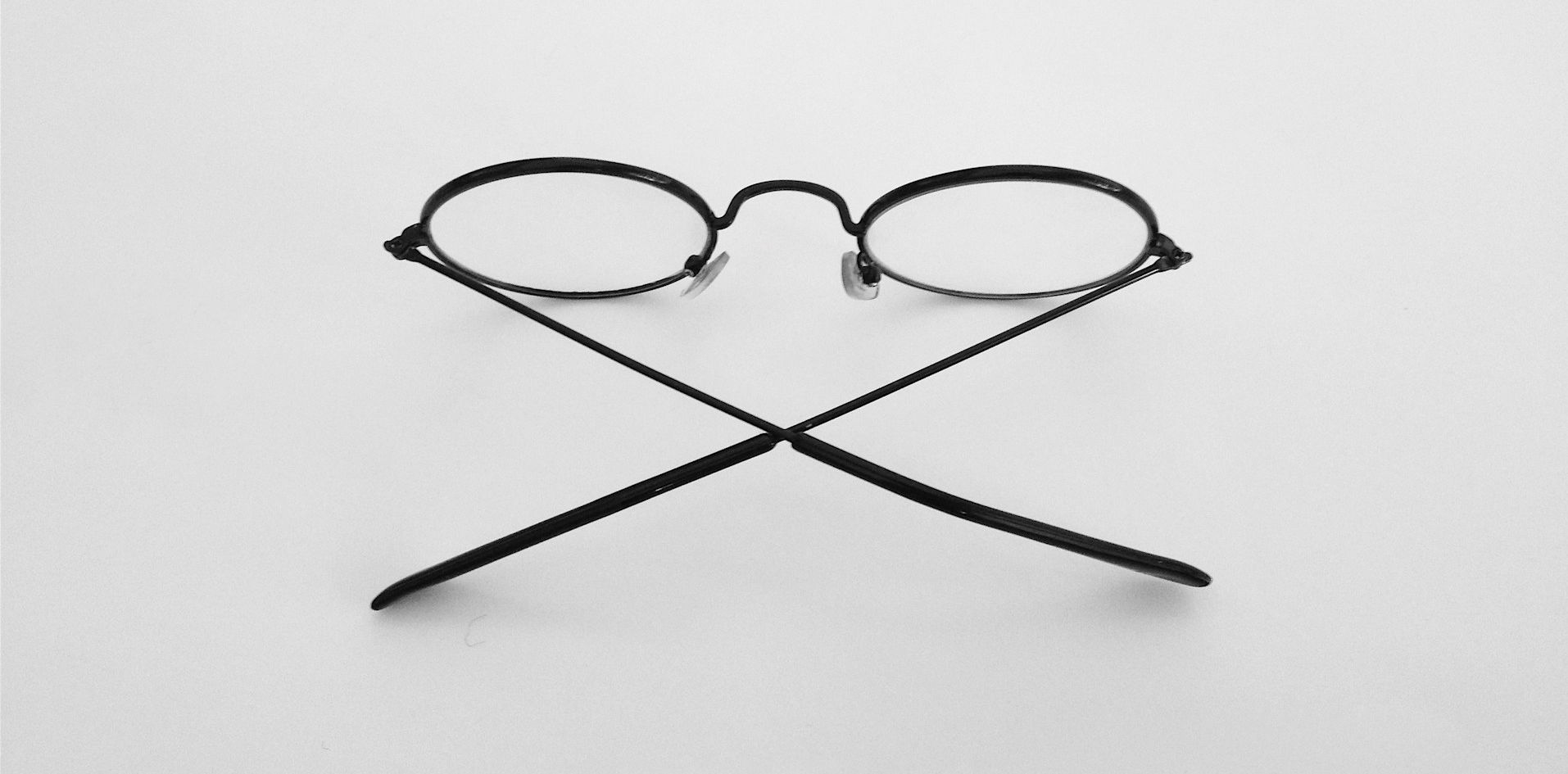 schwarz gerahmte Brille auf weißer Oberfläche